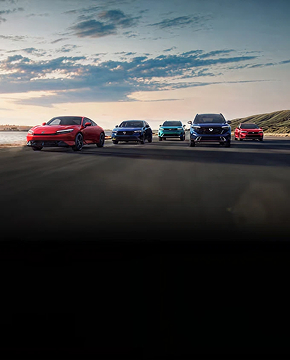 Honda Hybrid Vehicle Lineup parked side by side on an open road at sunset